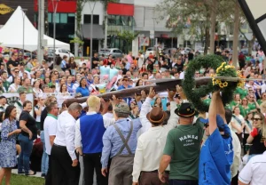 Participantes erguem a Schützenbaum em frente ao público na Praça Ângelo Piazera, em Jaraguá do Sul